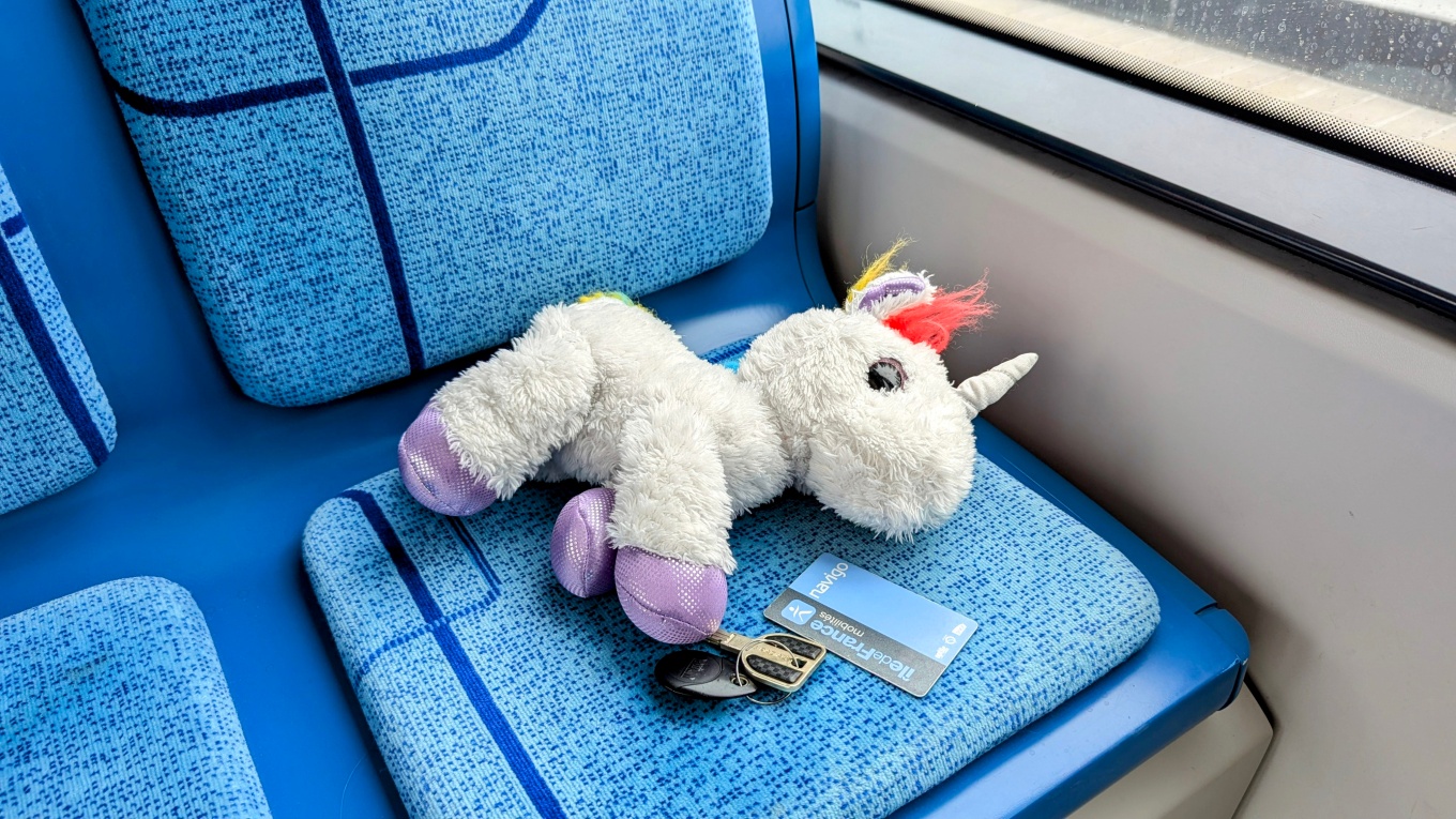 Photo of various lost objects on a bench seat on a bus