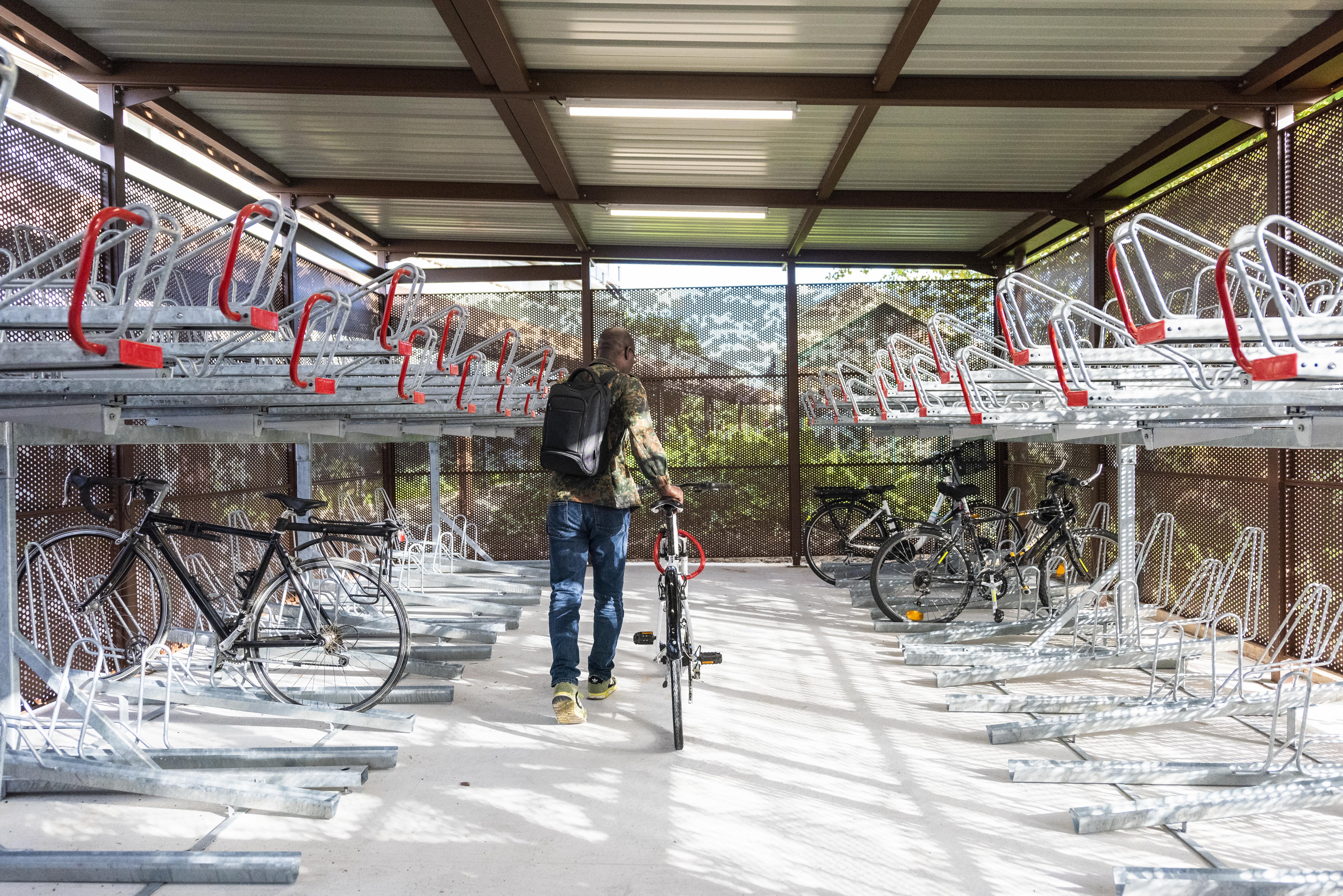 A person in a bicycle parking lot at Île-de-France Mobilités