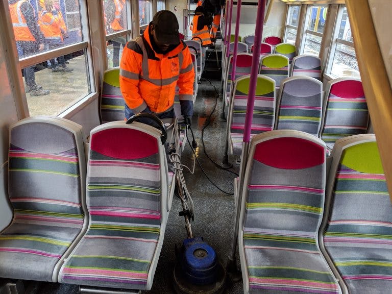 Personnes qui nettoient l'intérieur d'un bus